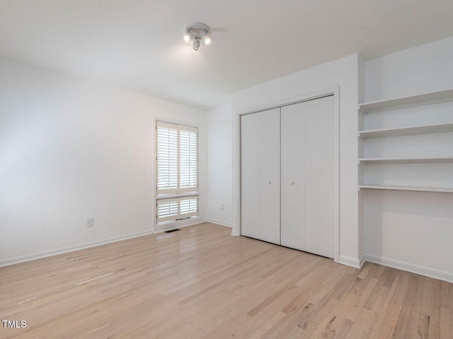 3205 Dell Dr, Raleigh, NC 27609 - unfurnished bedroom with wood finished floors and a closet