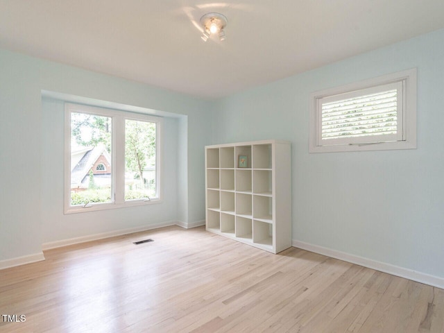3205 Dell Dr, Raleigh, NC 27609 - spare room featuring plenty of natural light and wood finished floors