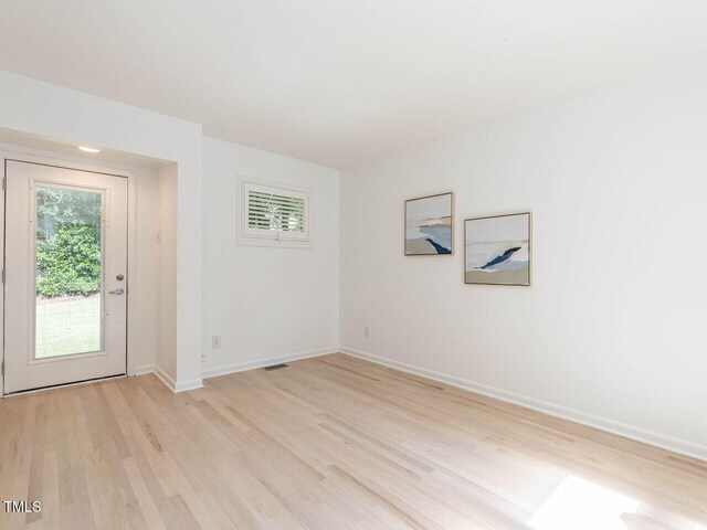 3205 Dell Dr, Raleigh, NC 27609 - empty room with light wood finished floors and baseboards