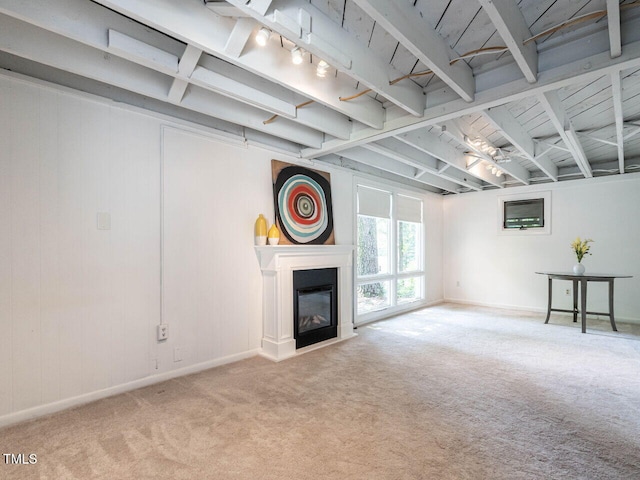 3205 Dell Dr, Raleigh, NC 27609 - unfurnished living room with carpet flooring, a glass covered fireplace, and beamed ceiling