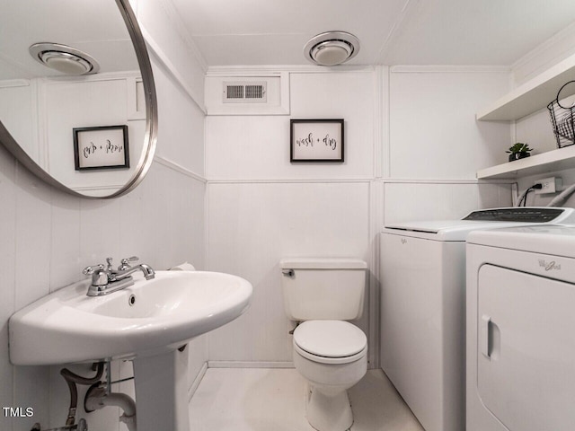 3205 Dell Dr, Raleigh, NC 27609 - half bathroom featuring washer and dryer and a decorative wall