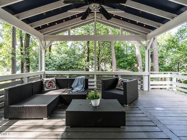 3205 Dell Dr, Raleigh, NC 27609 - wooden deck featuring an outdoor living space, ceiling fan, view of scattered trees, and a gazebo