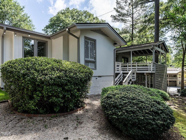 3205 Dell Dr, Raleigh, NC 27609 - view of property exterior featuring a deck and stairway