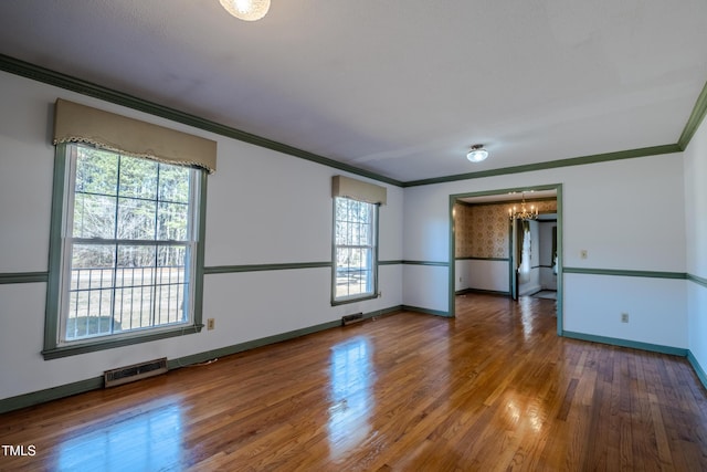 3129 Barwell Rd, Raleigh, NC 27610 - unfurnished room with a chandelier, wood finished floors, and ornamental molding