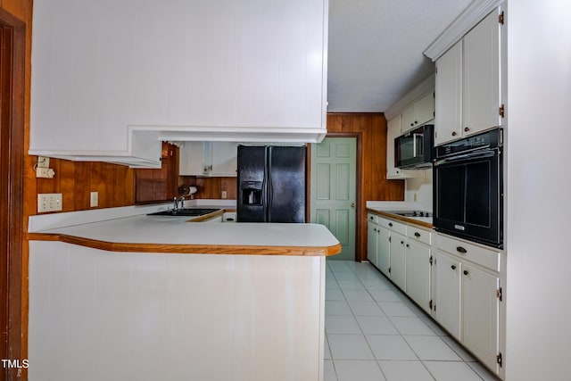 3129 Barwell Rd, Raleigh, NC 27610 - kitchen featuring black appliances, a peninsula, light countertops, light tile patterned floors, and white cabinets