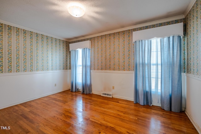 3129 Barwell Rd, Raleigh, NC 27610 - empty room with ornamental molding, wood finished floors, and a wainscoted wall