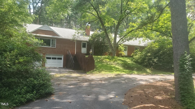 303 Holland Rd, Fuquay Varina, NC 27526 - ranch-style home with driveway, brick siding, an attached garage, and a chimney