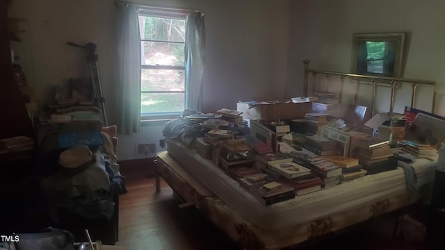 303 Holland Rd, Fuquay Varina, NC 27526 - bedroom featuring multiple windows and wood finished floors
