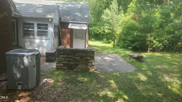 303 Holland Rd, Fuquay Varina, NC 27526 - exterior view of brick siding, a shingled roof, gutters, and a downspout
