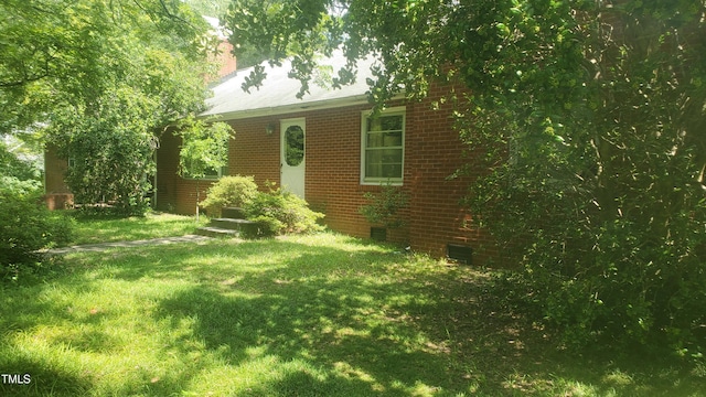 303 Holland Rd, Fuquay Varina, NC 27526 - view of front of house with a front lawn, brick siding, and a chimney