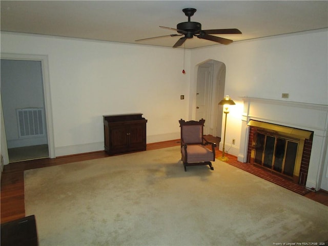 432 Rollingwood Cir, Fayetteville, NC 28305 - unfurnished room featuring ceiling fan, arched walkways, wood finished floors, and a fireplace