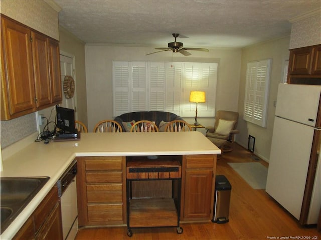 432 Rollingwood Cir, Fayetteville, NC 28305 - kitchen with freestanding refrigerator, a peninsula, light wood-type flooring, dishwasher, and ceiling fan