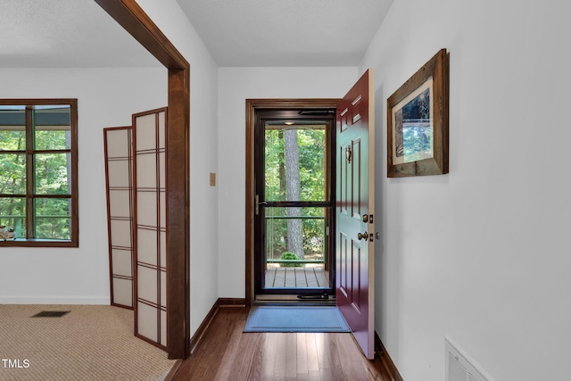 4134 King Charles Rd, Durham, NC 27707 - doorway to outside featuring wood finished floors and baseboards