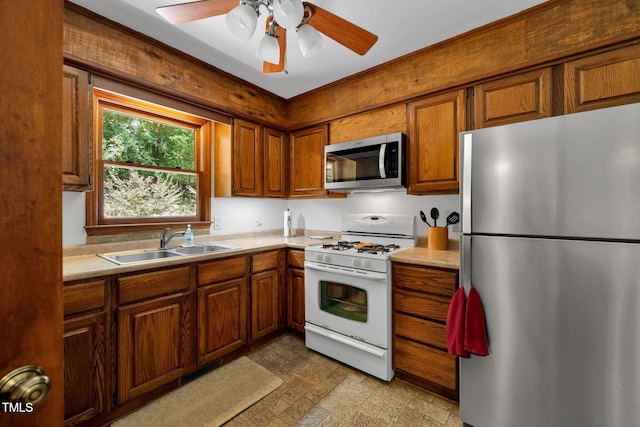 4134 King Charles Rd, Durham, NC 27707 - kitchen with appliances with stainless steel finishes, brown cabinets, light countertops, and ceiling fan