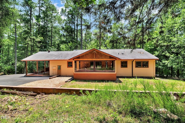 4134 King Charles Rd, Durham, NC 27707 - back of house with a patio, driveway, and a shingled roof