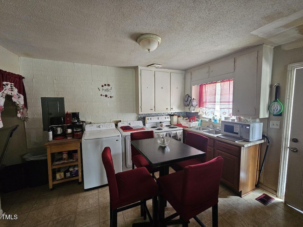 401 S Raleigh St A-B, Unit A-B Angier, NC 27501 - kitchen with white electric stove, washer and dryer, electric panel, light countertops, and a textured ceiling
