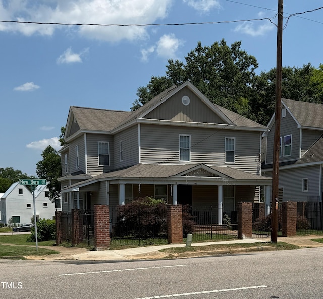 903 New Bern Ave, Raleigh, NC 27601 - view of front facade featuring a fenced front yard, a shingled roof, covered porch, and board and batten siding