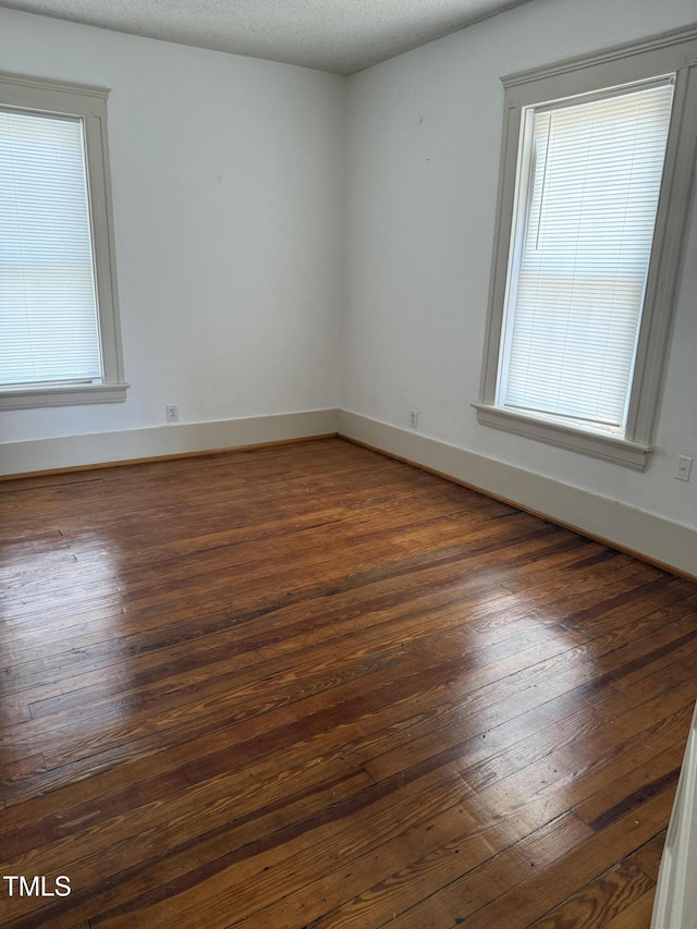 903 New Bern Ave, Raleigh, NC 27601 - spare room with dark wood finished floors and healthy amount of natural light