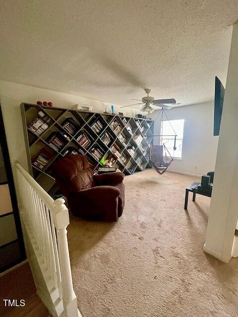 6328 Bermuda Way, Whitsett, NC 27377 - living area with carpet, a textured ceiling, and ceiling fan