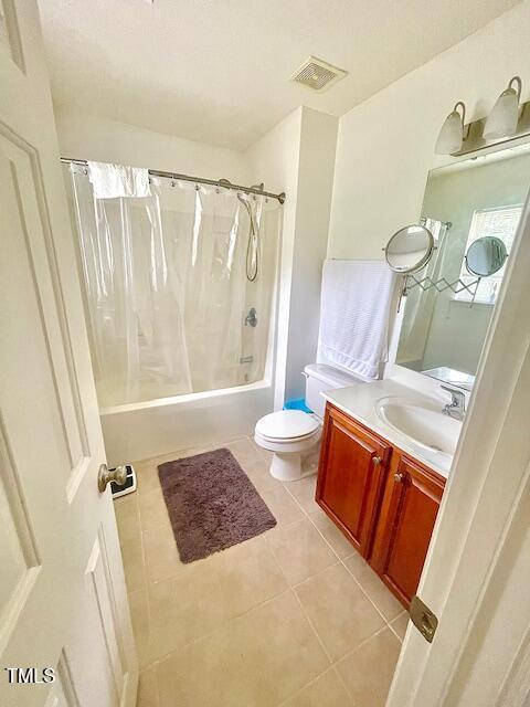 6328 Bermuda Way, Whitsett, NC 27377 - full bath featuring shower / tub combo with curtain, vanity, and tile patterned flooring