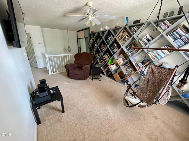 6328 Bermuda Way, Whitsett, NC 27377 - living area with an upstairs landing, a textured ceiling, a ceiling fan, and carpet floors