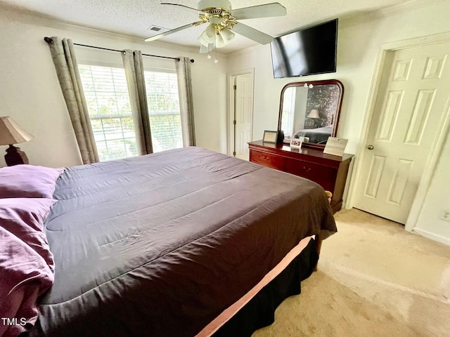 6328 Bermuda Way, Whitsett, NC 27377 - bedroom featuring light colored carpet, a ceiling fan, and a textured ceiling