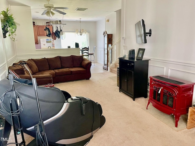 6328 Bermuda Way, Whitsett, NC 27377 - living area featuring a decorative wall, a ceiling fan, light colored carpet, wainscoting, and stairway
