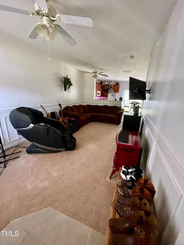 6328 Bermuda Way, Whitsett, NC 27377 - carpeted living area with a decorative wall, a wainscoted wall, and a ceiling fan