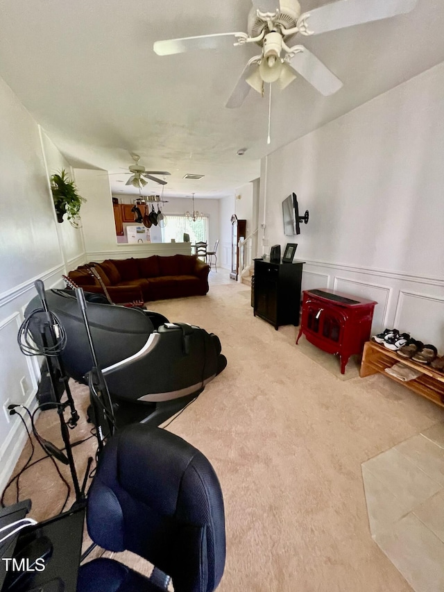 6328 Bermuda Way, Whitsett, NC 27377 - living area featuring ceiling fan, a decorative wall, carpet flooring, and a wainscoted wall