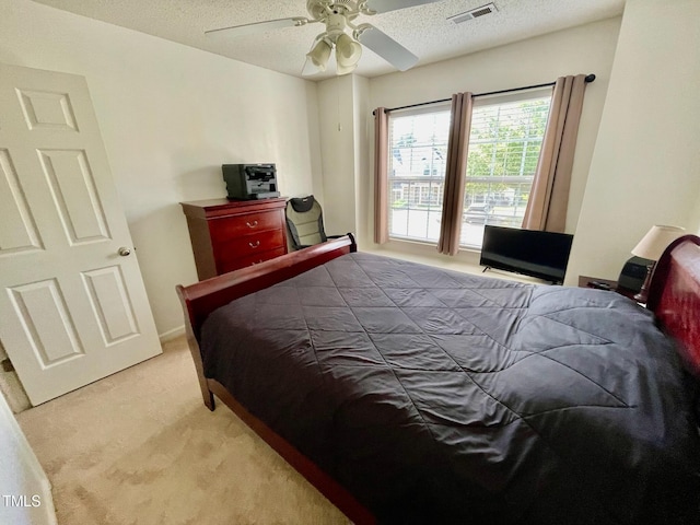 6328 Bermuda Way, Whitsett, NC 27377 - bedroom featuring light colored carpet, a textured ceiling, and a ceiling fan