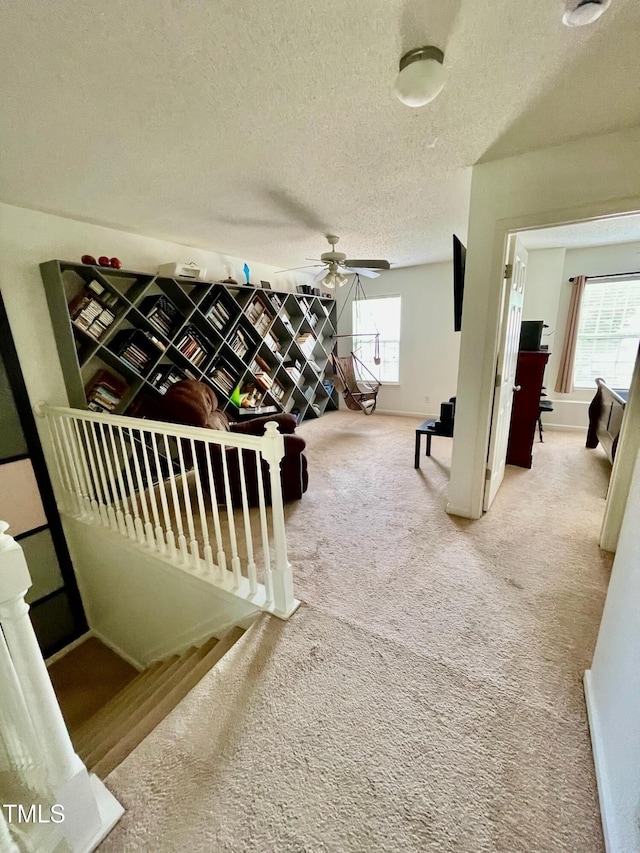 6328 Bermuda Way, Whitsett, NC 27377 - interior space featuring an upstairs landing, healthy amount of natural light, a textured ceiling, and carpet flooring