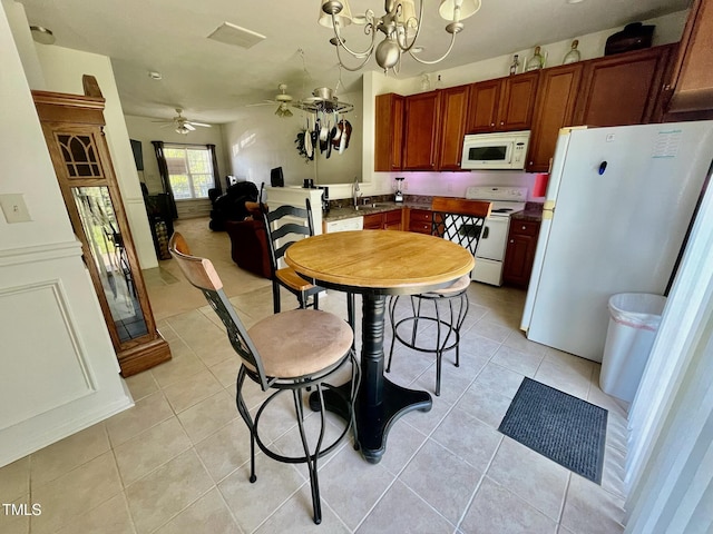6328 Bermuda Way, Whitsett, NC 27377 - dining space with light tile patterned floors, a chandelier, and a ceiling fan