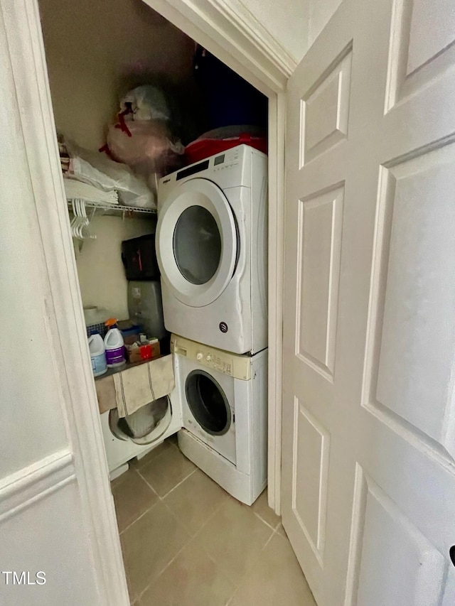 6328 Bermuda Way, Whitsett, NC 27377 - laundry room with estacked washer and dryer and tile patterned flooring