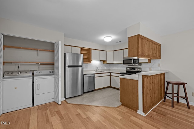 365 Summerwalk Cir, Chapel Hill, NC 27517 - kitchen with stainless steel appliances, open shelves, a peninsula, and tasteful backsplash