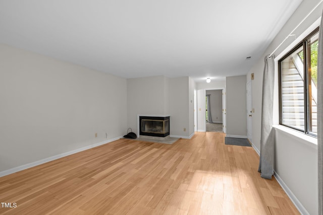 365 Summerwalk Cir, Chapel Hill, NC 27517 - unfurnished living room with light wood finished floors and a multi sided fireplace