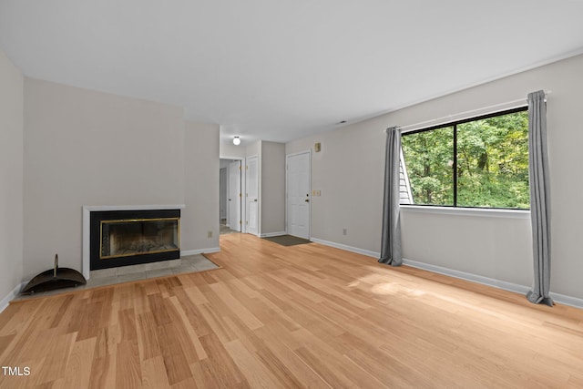 365 Summerwalk Cir, Chapel Hill, NC 27517 - unfurnished living room with wood finished floors and a tiled fireplace