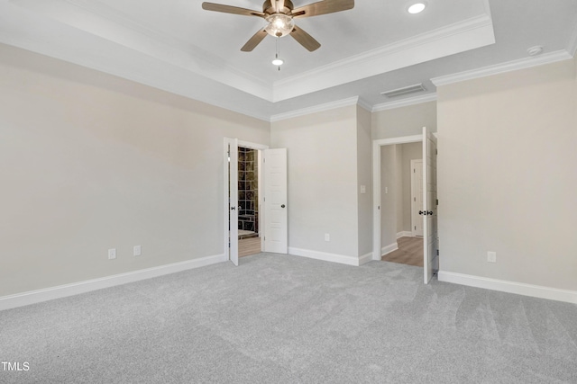 157 Cherrybirch Ln, Zebulon, NC 27597 - unfurnished bedroom featuring a tray ceiling, ornamental molding, light carpet, ceiling fan, and recessed lighting