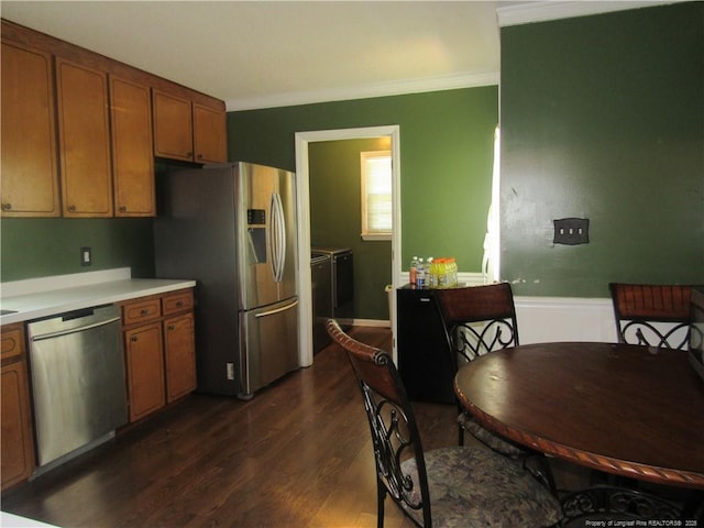 108 Shady Meadows Ln, Clayton, NC 27520 - kitchen featuring appliances with stainless steel finishes, independent washer and dryer, dark wood-style floors, brown cabinetry, and light countertops