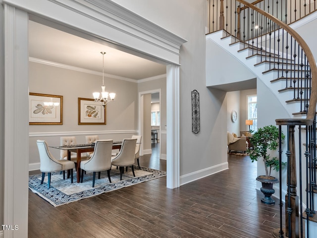 3526 Clifton Park Ct, New Hill, NC 27562 - dining area featuring a chandelier, plenty of natural light, stairs, wood finished floors, and ornamental molding
