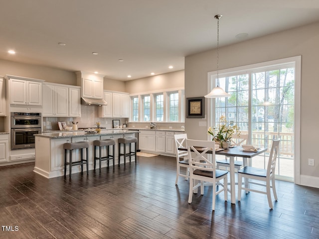 3526 Clifton Park Ct, New Hill, NC 27562 - dining space with dark wood-type flooring and recessed lighting
