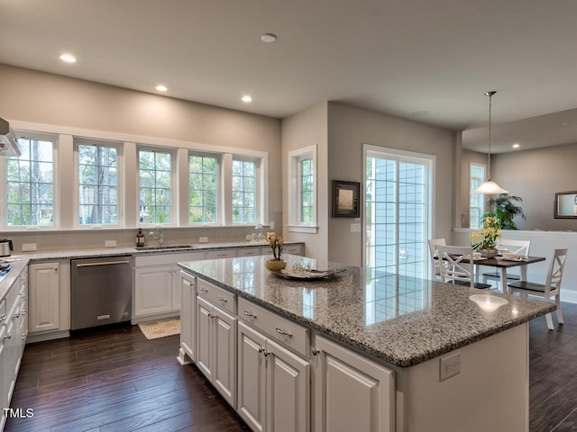 3526 Clifton Park Ct, New Hill, NC 27562 - kitchen featuring dishwasher, a center island, white cabinets, dark wood-style flooring, and light stone counters
