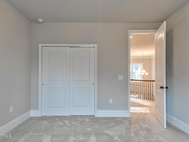3526 Clifton Park Ct, New Hill, NC 27562 - unfurnished bedroom with a chandelier, carpet flooring, and a closet