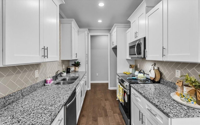 213 Guerrant St, Greensboro, NC 27401 - kitchen with appliances with stainless steel finishes, light stone countertops, white cabinetry, decorative backsplash, and recessed lighting