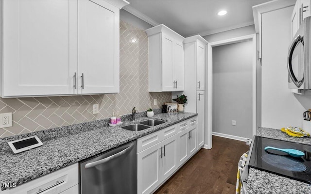 213 Guerrant St, Greensboro, NC 27401 - kitchen with stainless steel appliances, tasteful backsplash, white cabinets, ornamental molding, and recessed lighting