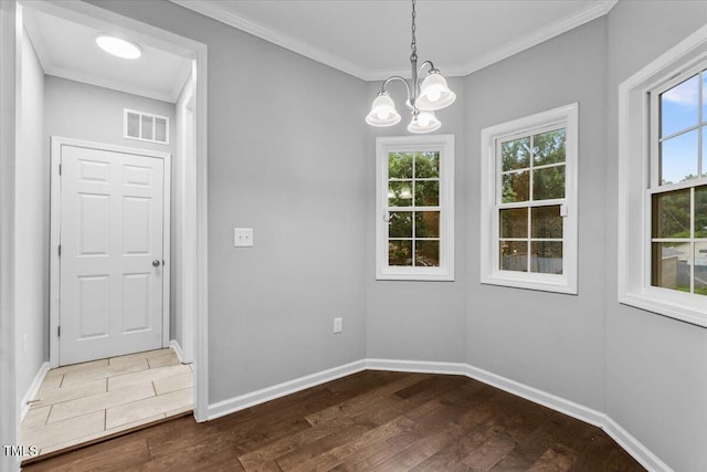 213 Guerrant St, Greensboro, NC 27401 - unfurnished dining area with wood finished floors, a chandelier, and ornamental molding
