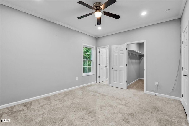 213 Guerrant St, Greensboro, NC 27401 - unfurnished bedroom with carpet floors, ornamental molding, a walk in closet, recessed lighting, and a ceiling fan