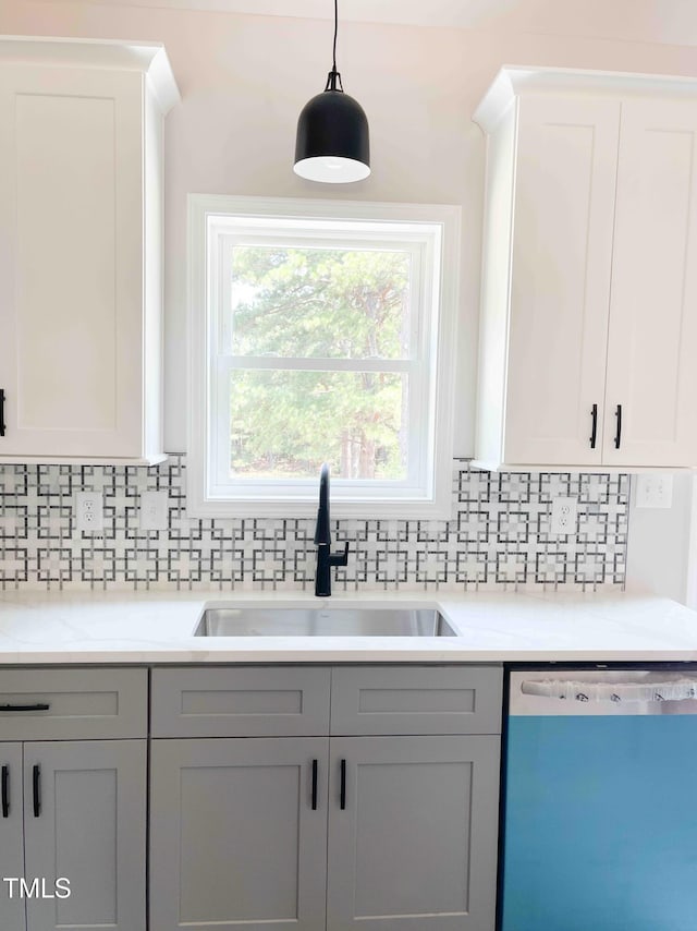 341 Rev Henderson Rd, Henderson, NC 27537 - kitchen featuring dishwashing machine, tasteful backsplash, light countertops, and pendant lighting