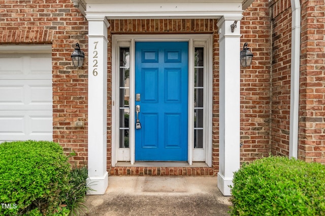 7226 Corvette Ct, Raleigh, NC 27613 - property entrance featuring brick siding and a garage