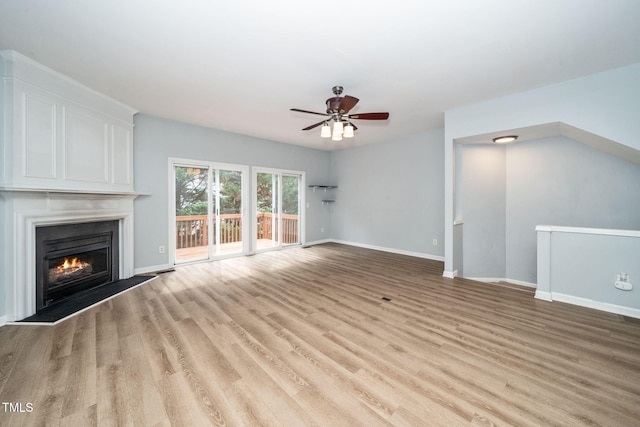 7226 Corvette Ct, Raleigh, NC 27613 - unfurnished living room with a ceiling fan, wood finished floors, and a large fireplace