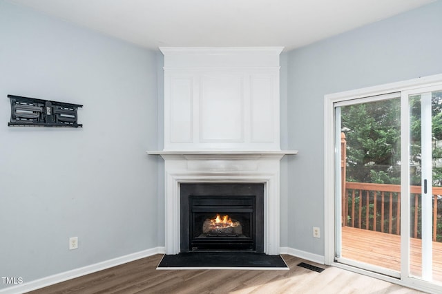 7226 Corvette Ct, Raleigh, NC 27613 - detailed view of wood finished floors and a fireplace